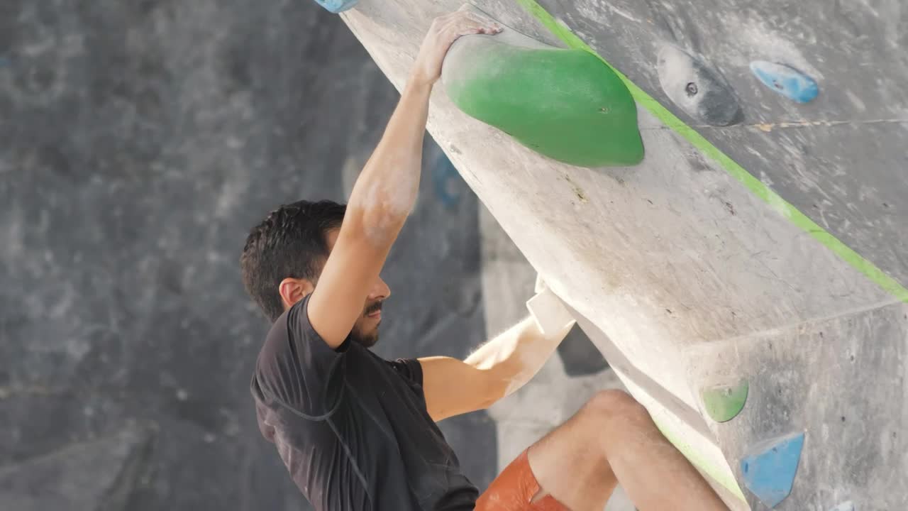 Stock Video Man Climbing Up A Sloping Mountaineering Wall Animated Wallpaper - Free Download