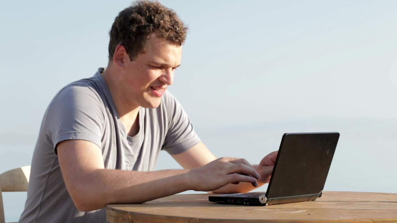 Stock Video Man Typing On A Small Personal Compute Animated Wallpaper - Free Download