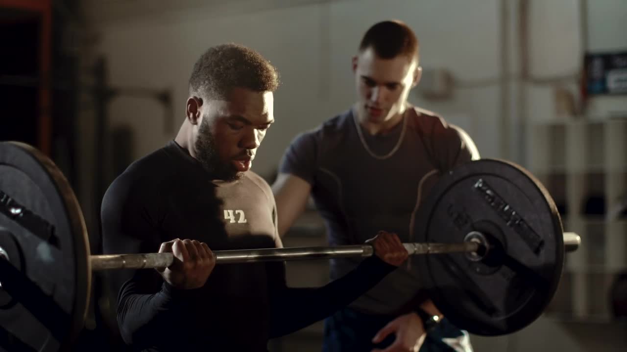 Stock Video Man Lifting Weights Supported By His Traine Animated Wallpaper - Free Download