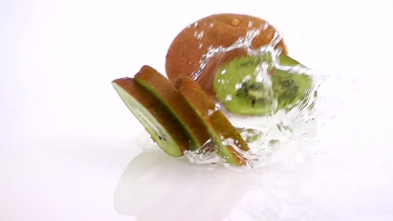 Free Video Stock Slices Of Kiwi Falling Into Water On White Background Live Wallpaper - Free Download