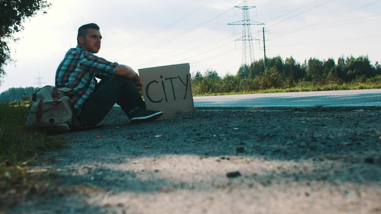 Stock Video Hitchhiker With A Cardboard Sign Animated Wallpaper - Free Download