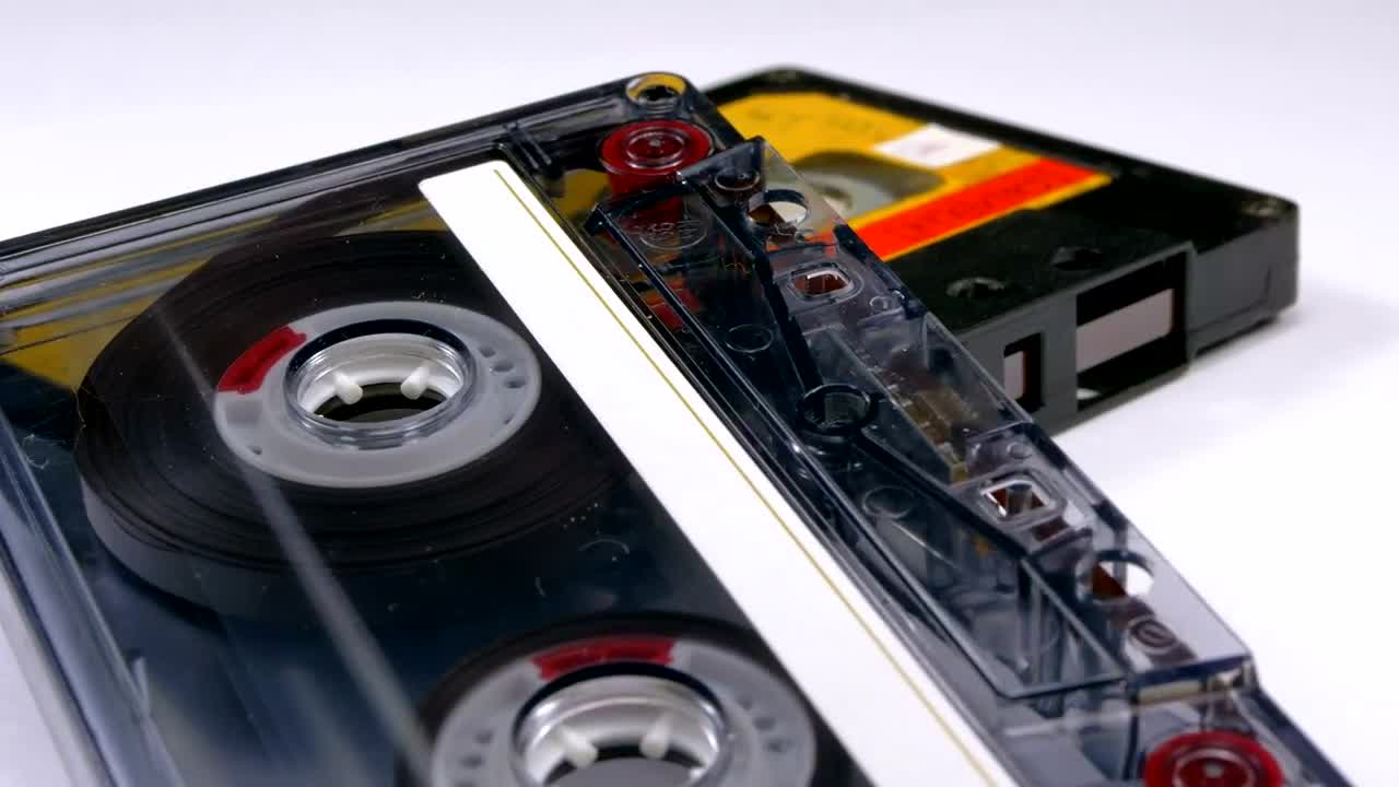 Video Stock Close Up Of Two Vintage Audio Cassettes Rotating Live Wallpaper For PC - Free Download