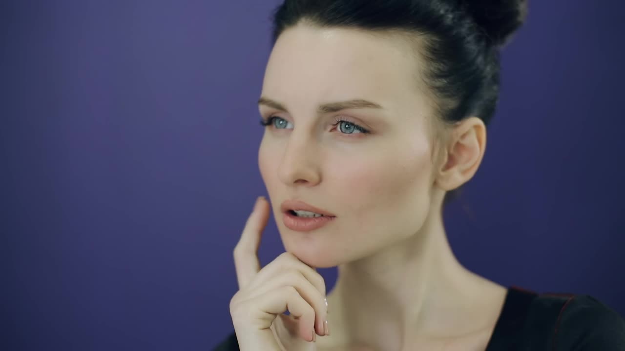 Stock Video Face Of A Young Pensive Woman On A Purple Background Live Wallpaper For PC - Free Download