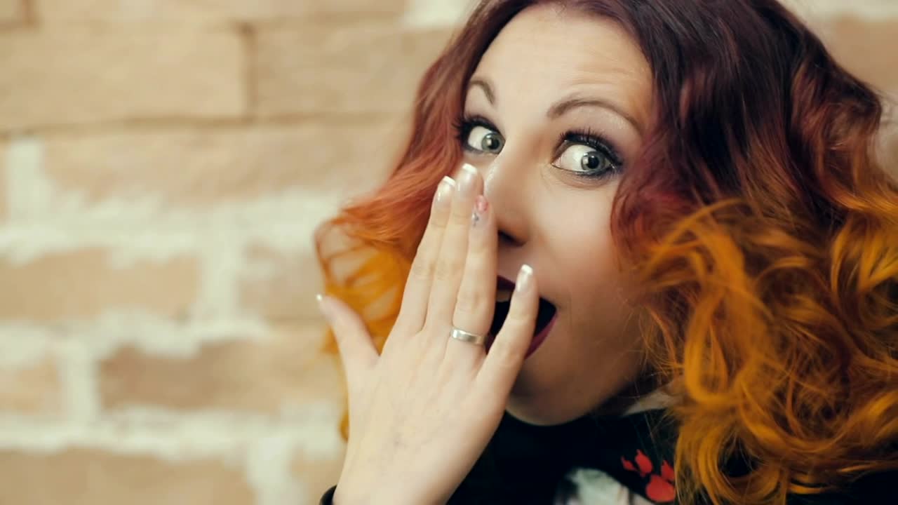 Free Video Stock surprised young woman covers her mouth Live Wallpaper - Free Download