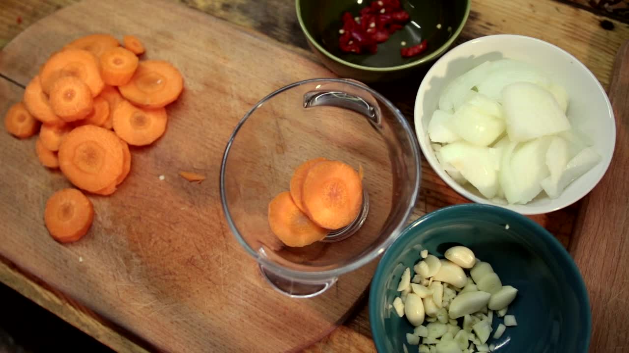 Stock Footage Woman Adding Chopped Carrots To A Bowl Live Wallpaper - Free Download