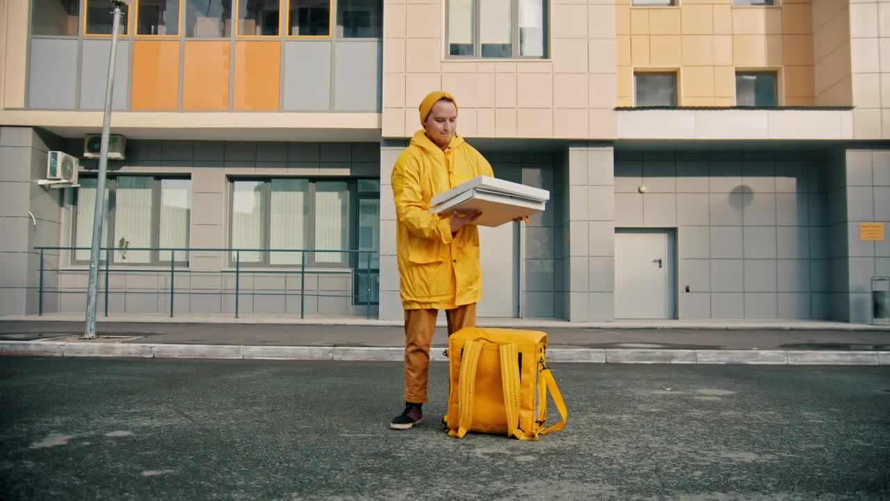 Stock Video Courier Man With Yellow Uniform Opens A Pizza Box Live Wallpaper For PC - Free Download