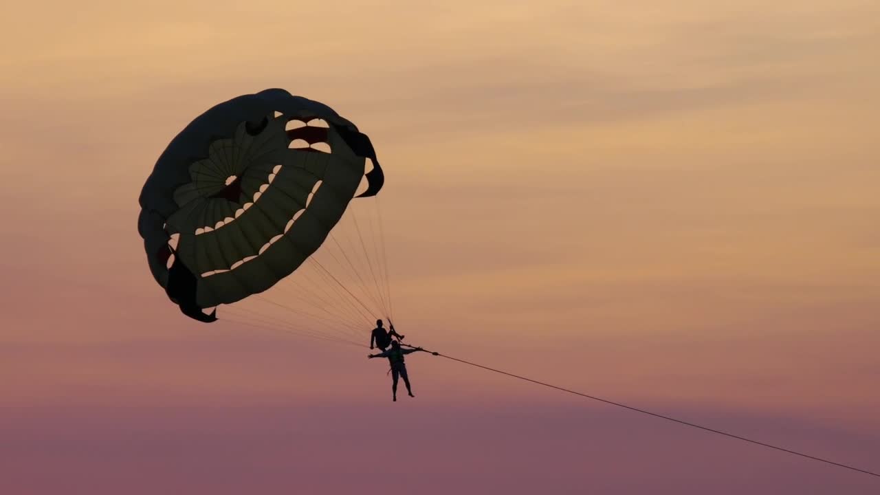 Stock Video Couple Doing Recreational Parasailing In The Sunset Live Wallpaper For PC - Free Download