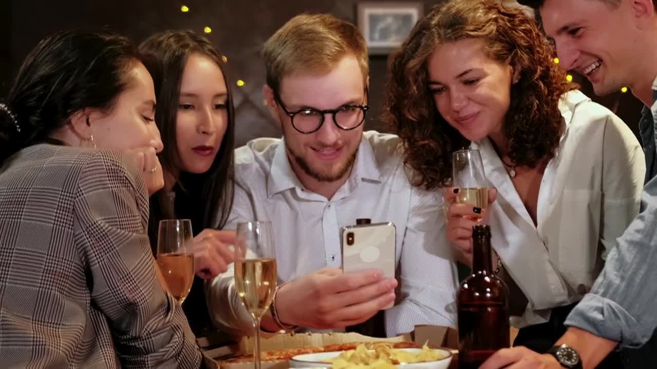Stock Video Friends Celebrating A Special Date Look At A Cell Phone Live Wallpaper For PC - Free Download