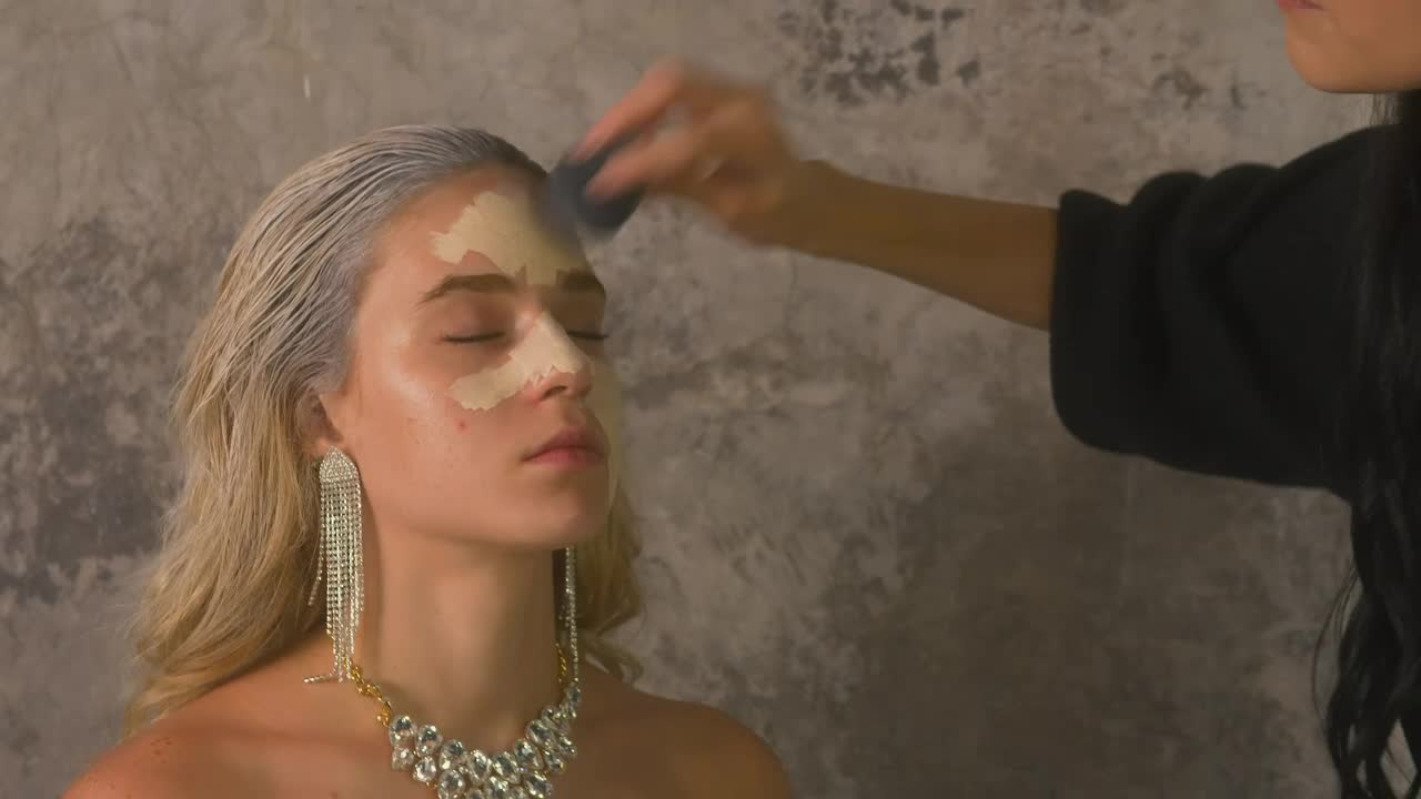 Stock Video Makeup Artist Applying Base To A Models Face Animated Wallpaper - Free Download