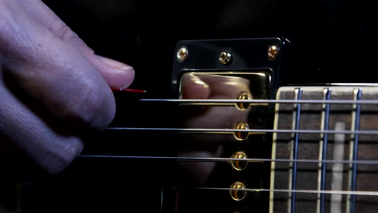 Stock Video Holding A Guitar Pick Animated Wallpaper - Free Download