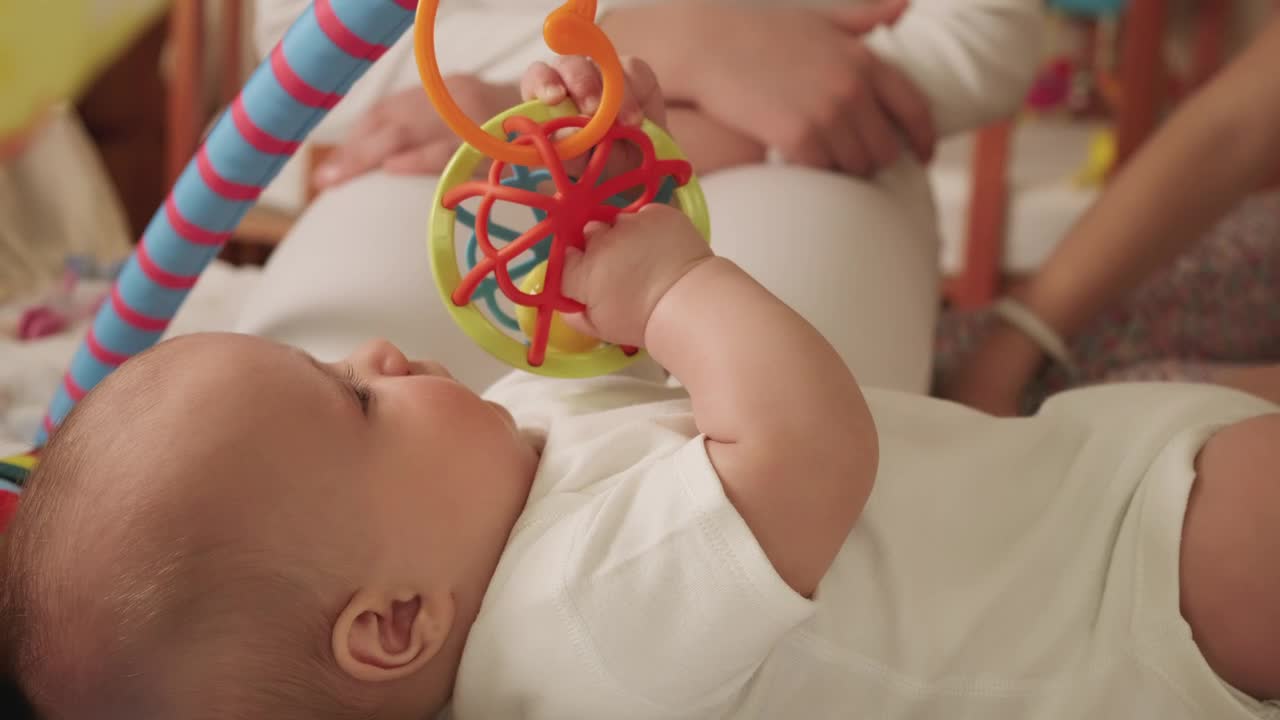 Stock Video Little Baby Playing With Toys In Bed Animated Wallpaper - Free Download