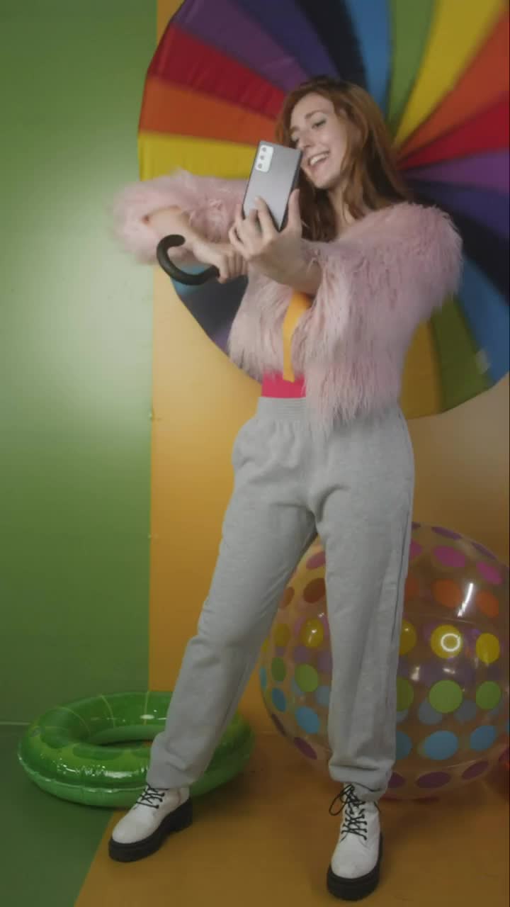 Video Stock Cheerful Girl Recording Herself With A Colorful Background Live Wallpaper For PC - Free Download