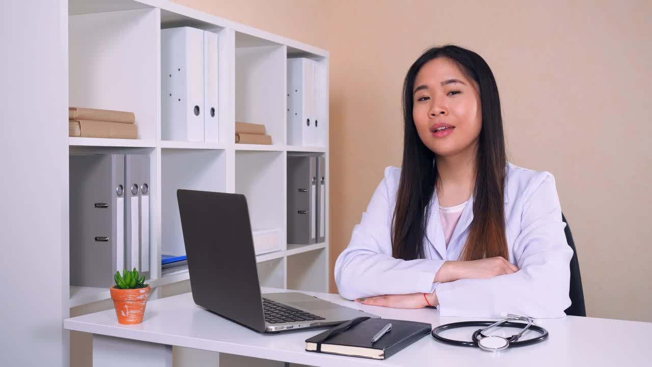 Stock Video Female Doctor In White Coat In Her Office Talking Live Wallpaper For PC - Free Download