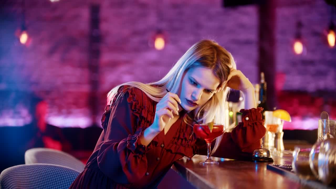 Free Video Stock thoughtful woman playing with her drink in a bar Live Wallpaper - Free Download