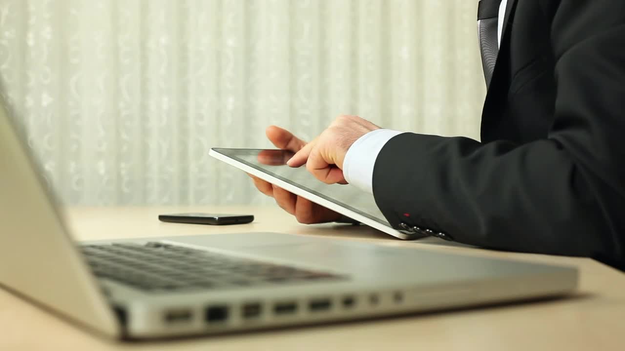 Video Stock Businessman Working With A Tablet In His Desktop Live Wallpaper For PC - Free Download