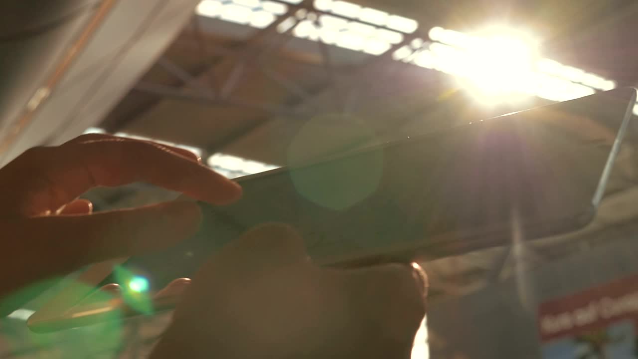 Stock Footage Using A Tablet Under Bright Sunshine Live Wallpaper - Free Download