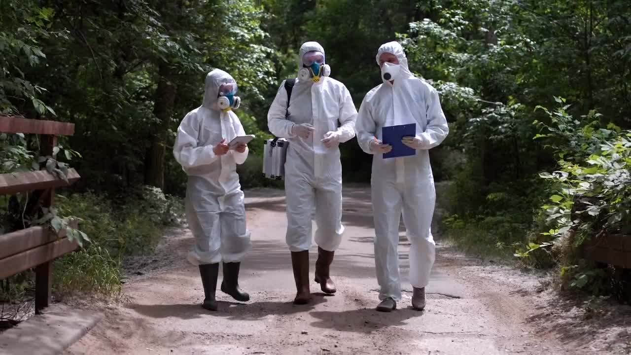 Stock Video People In Biohazard Suits Walking In The Forest Live Wallpaper - Free Download