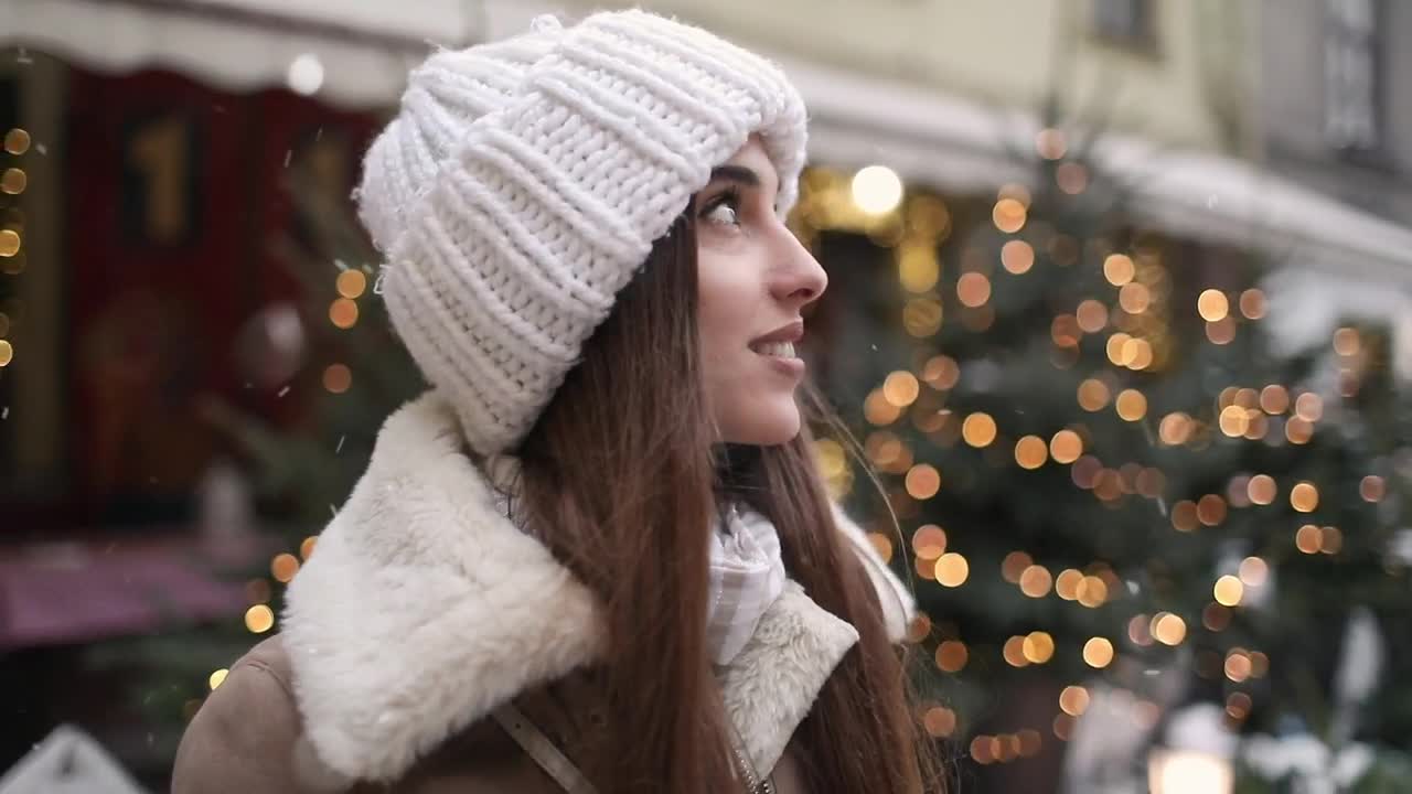 Free Video Stock Smiling Woman Enjoys Winter Snowflakes In Street Live Wallpaper - Free Download