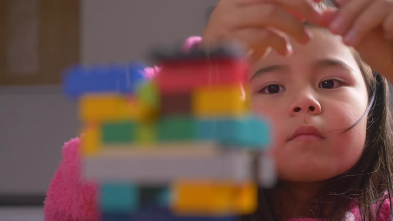 Stock Video Hands Of A Girl Putting Together A Figure With Legos Animated Wallpaper - Free Download