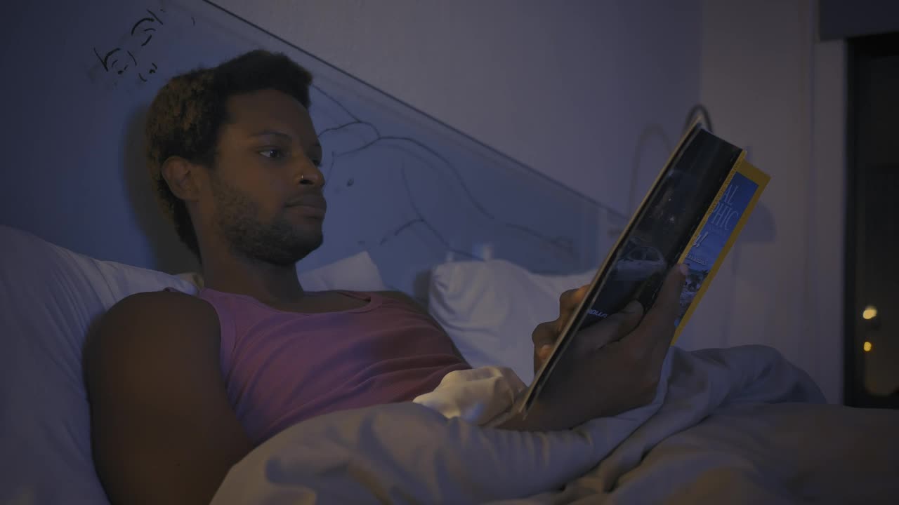 Free Stock Video Young Man Reading A Book Before Going To Sleep Live Wallpaper - Free Download
