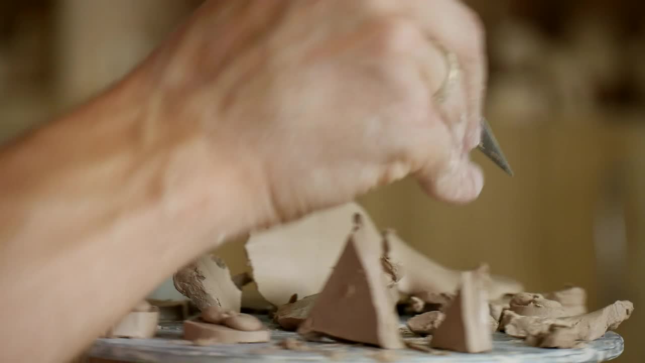 Stock Video Male Working On Clay With Cutting Tools Animated Wallpaper - Free Download