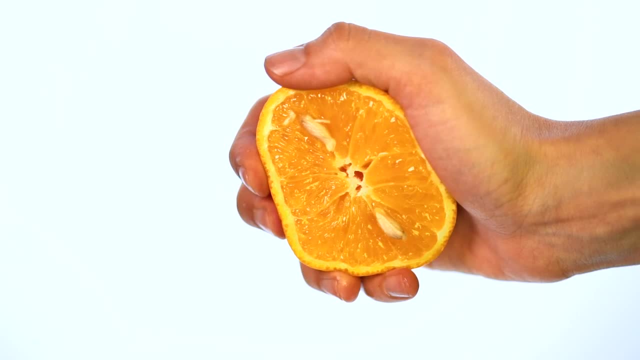 Stock Video Hand Of A Person Squeezing An Orange On A Light Live Wallpaper For PC - Free Download
