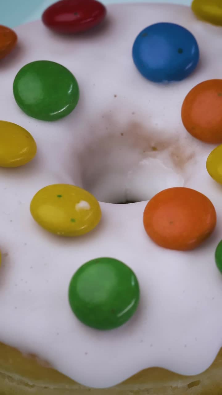 Free Video Stock texture of a glazed donut with colorful chocolates rotating Live Wallpaper - Free Download