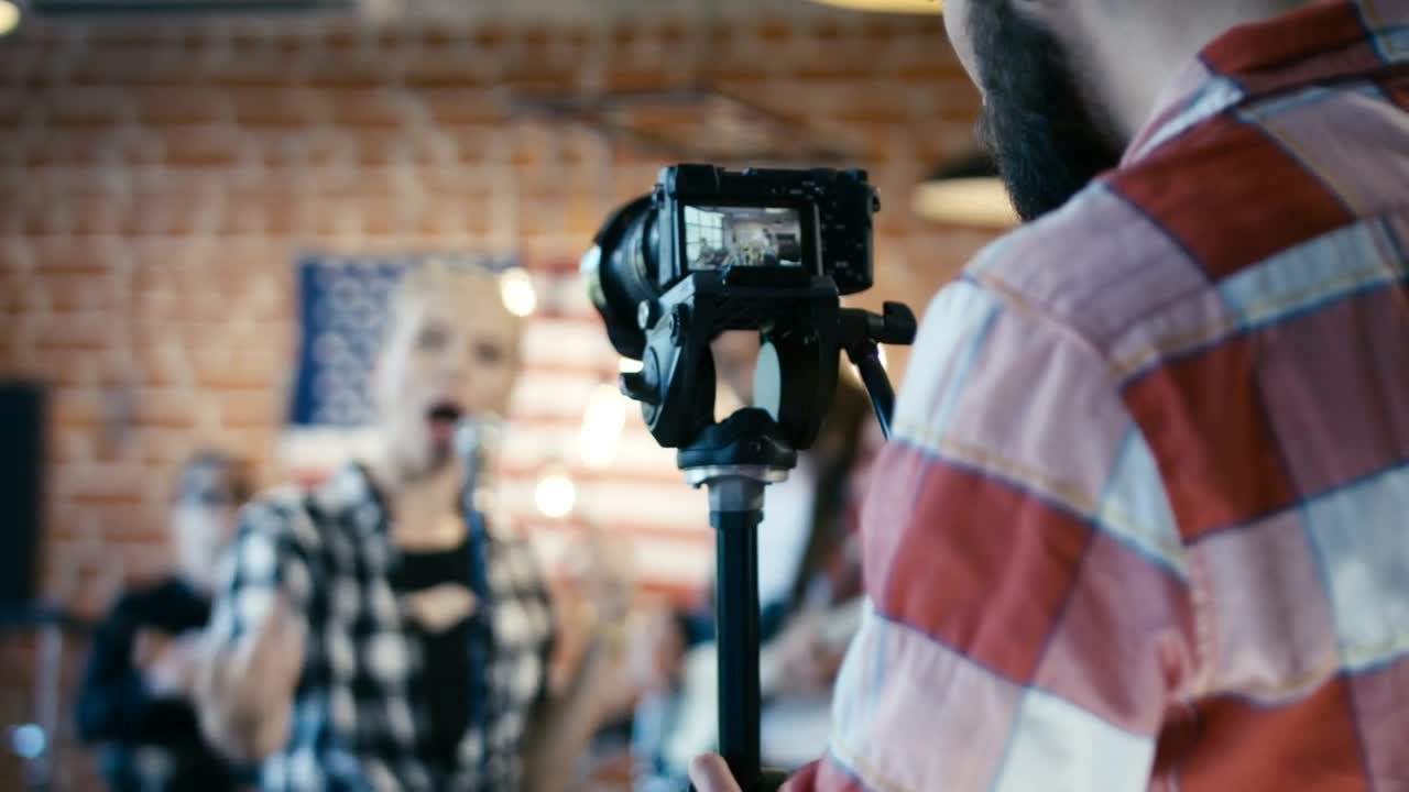 Stock Video Man Filming A Musical Band Animated Wallpaper - Free Download