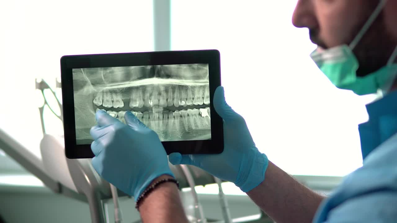 Stock Video Dental Nurse Explains Teeth X Ray On Tablet Live Wallpaper For PC - Free Download