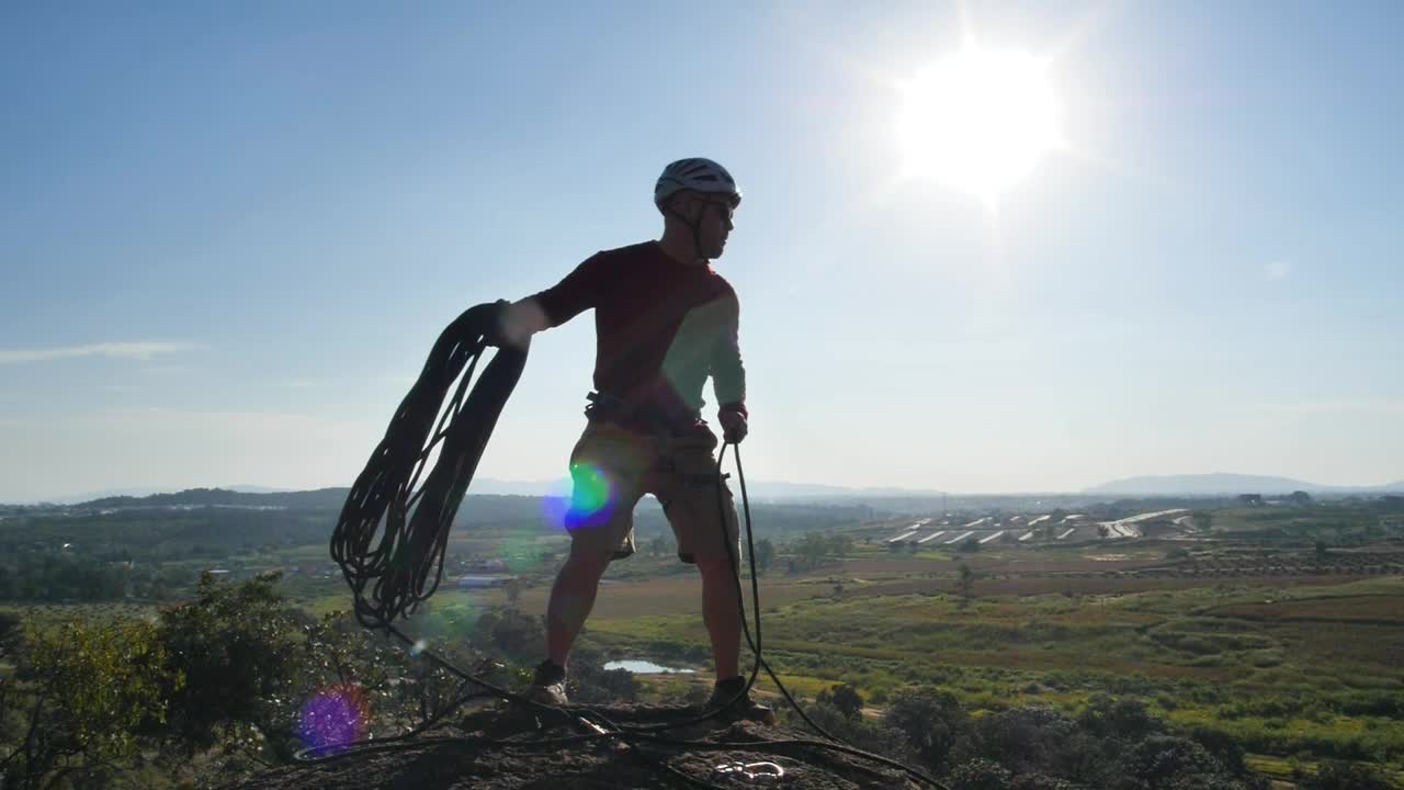 Stock Video Man Throwing A Rope From The Top Of A Hil Animated Wallpaper - Free Download