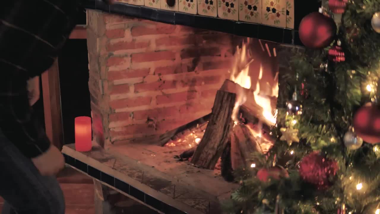 Stock Video Man Feeds The Fire From His Fireplace Animated Wallpaper - Free Download