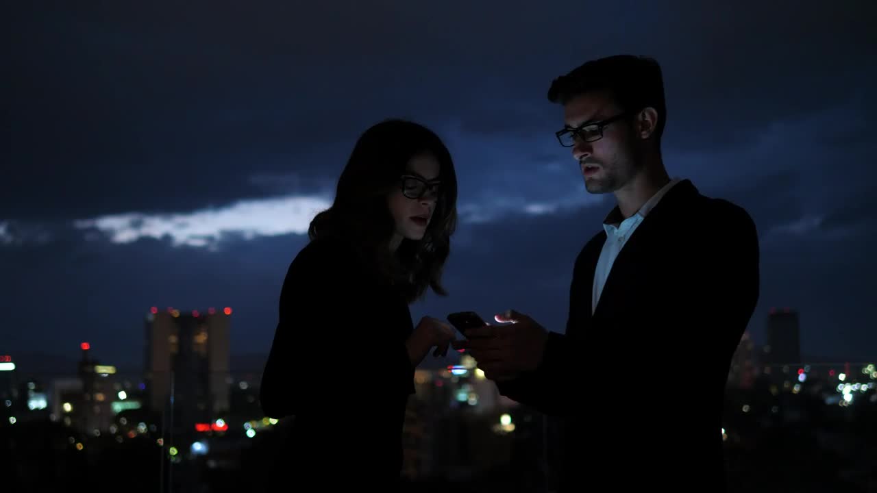 Stock Video Colleagues Looking At Information On Mobile Phone Screen Live Wallpaper For PC - Free Download