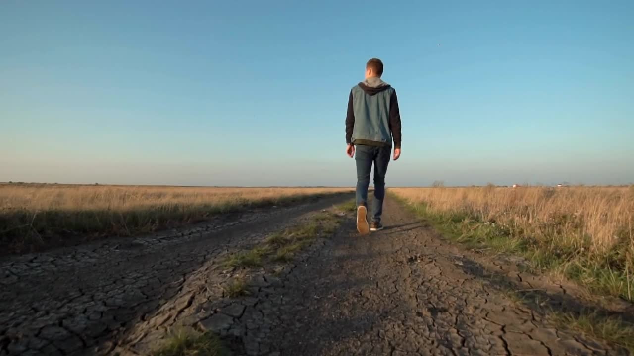 Stock Video Man Walking On A Rural Roa Animated Wallpaper - Free Download