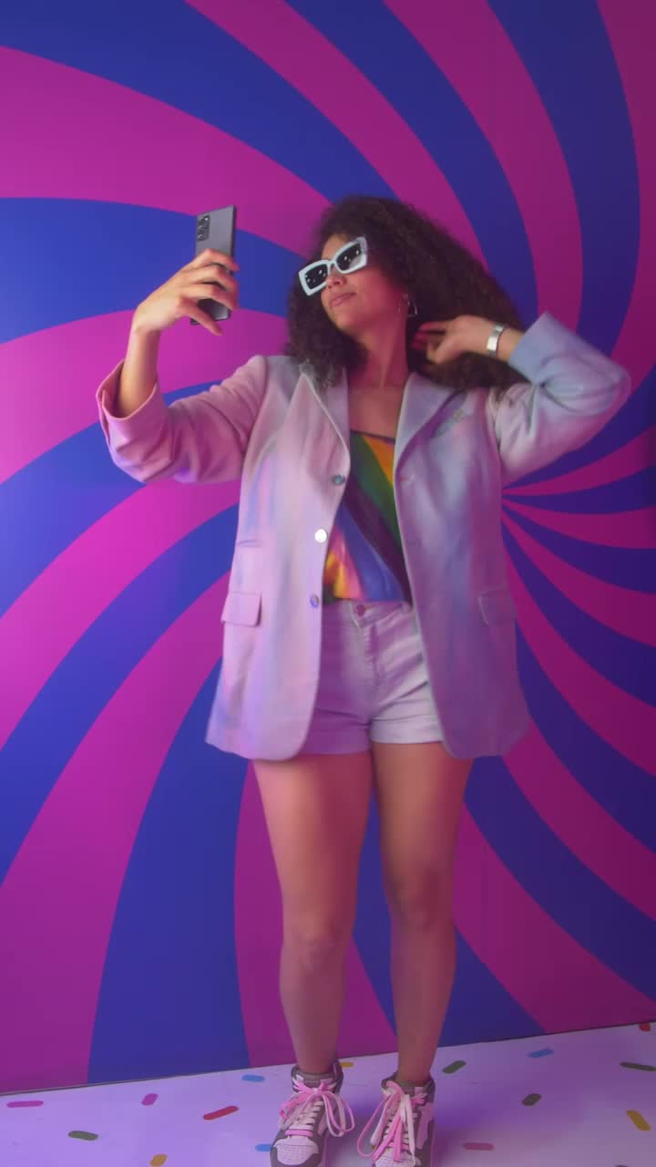 Stock Video Girl Recording Herself Dancing With A Colorful Background Live Wallpaper For PC - Free Download