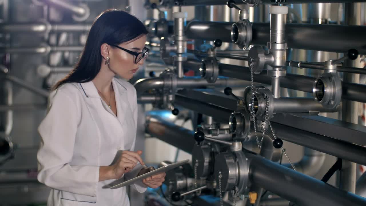 Stock Video Female Worker Checks Pressure Levels In Machines Live Wallpaper For PC - Free Download
