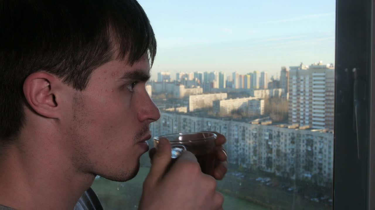Stock Video Man Sipping Tea By The Windo Animated Wallpaper - Free Download
