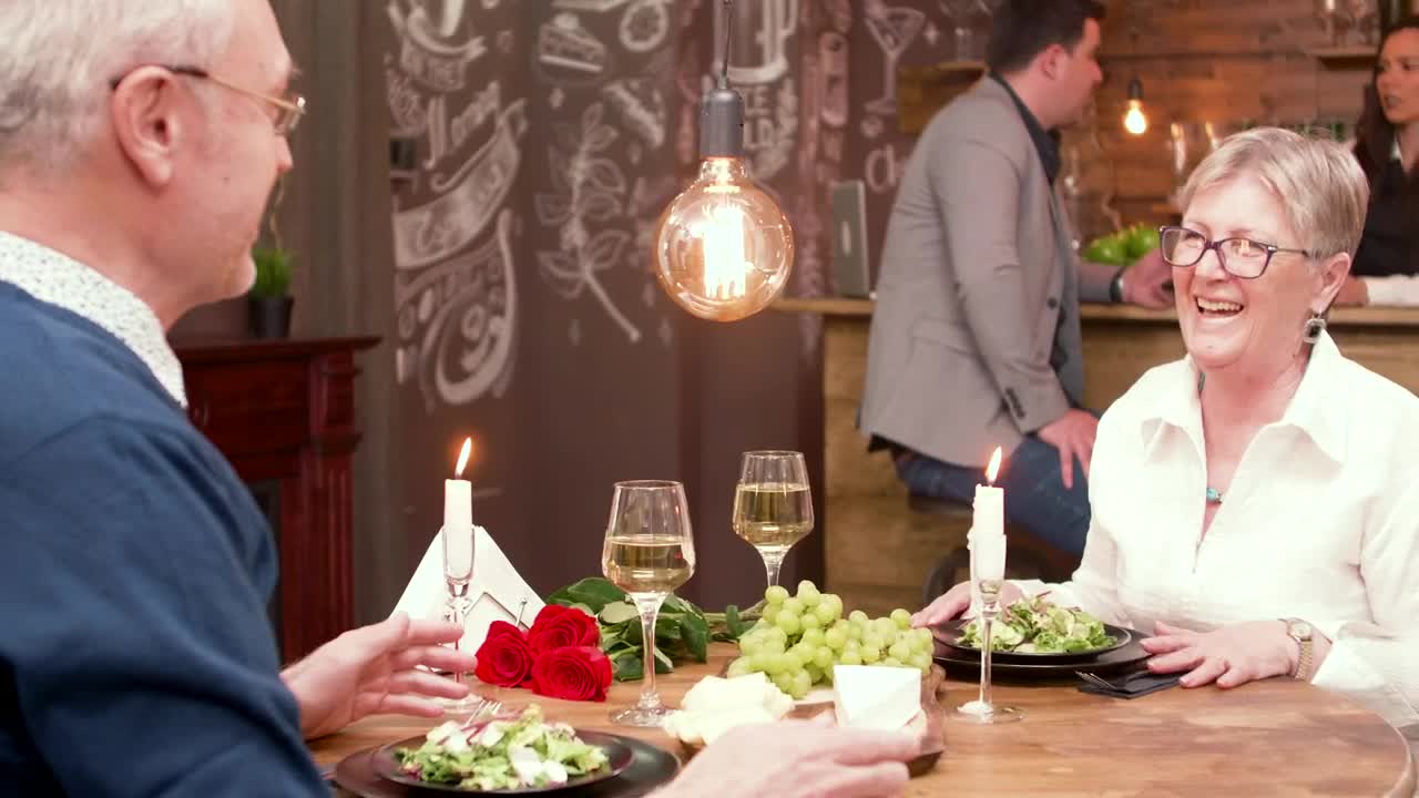 Stock Video Older Man Gives Woman Gift At Romantic Dinner Date Live Wallpaper - Free Download