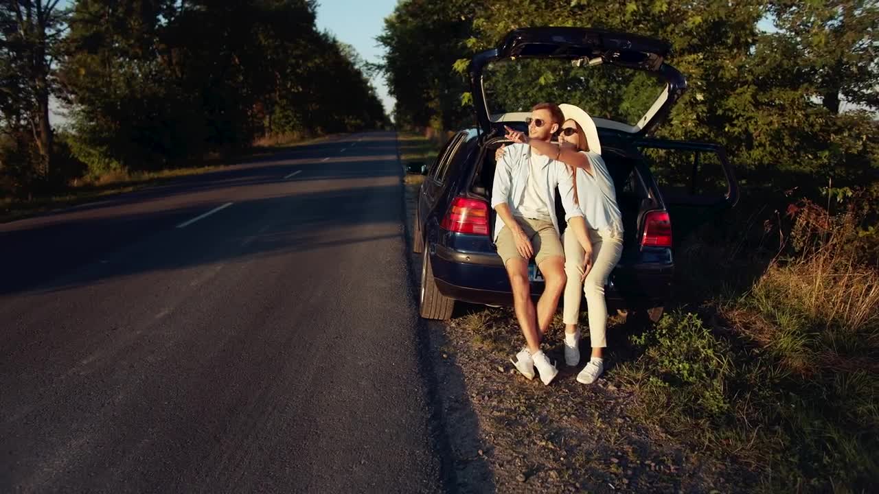 Video Stock Cinematic View Of Couple Sitting On Car In Countryside Live Wallpaper For PC - Free Download