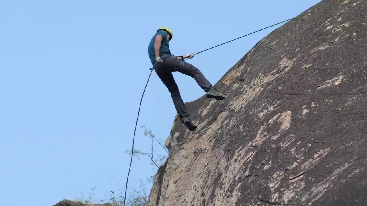 Stock Video Mountaineer Descending From A Rocky Mountain Live Wallpaper - Free Download