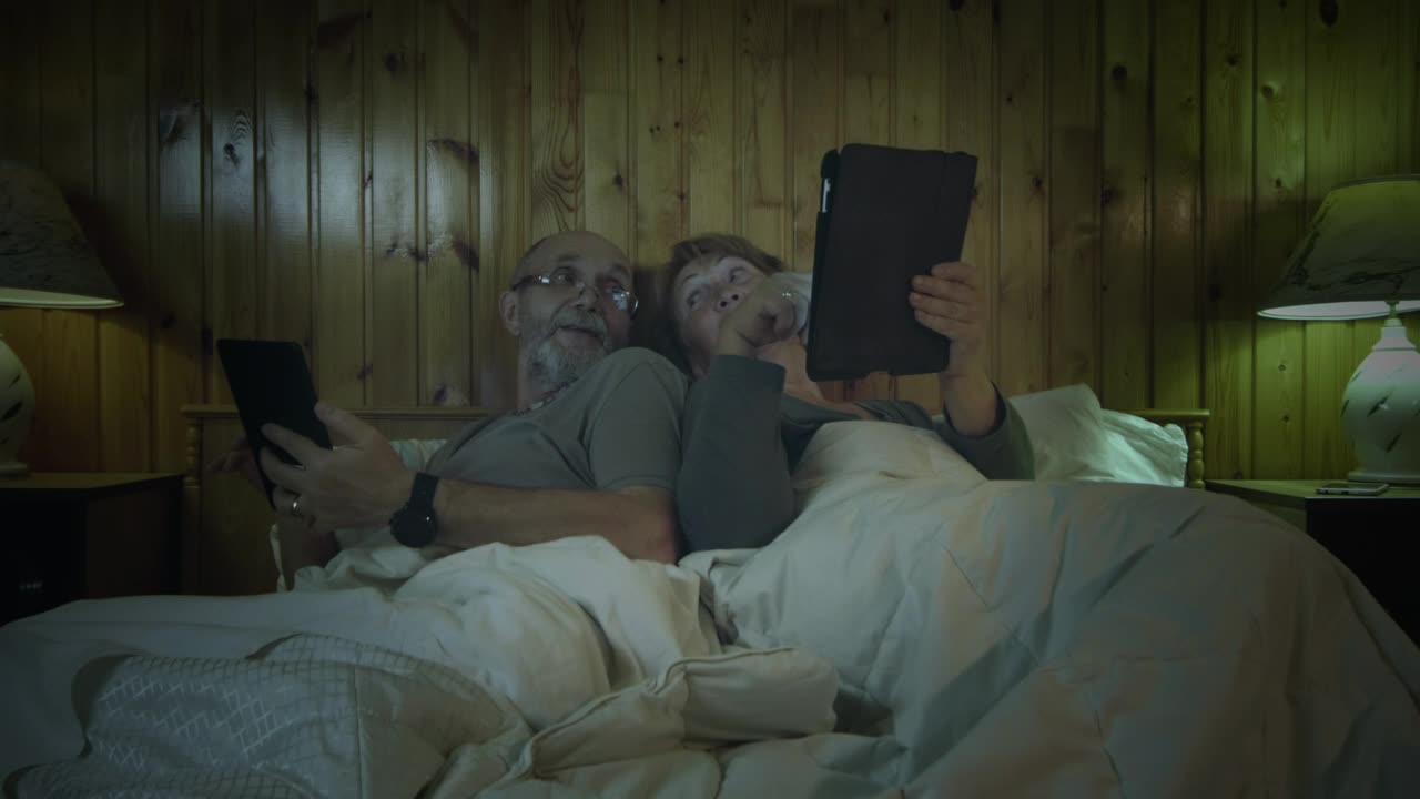 Stock Video Old Couple With Tablets In The Bedroom Live Wallpaper - Free Download