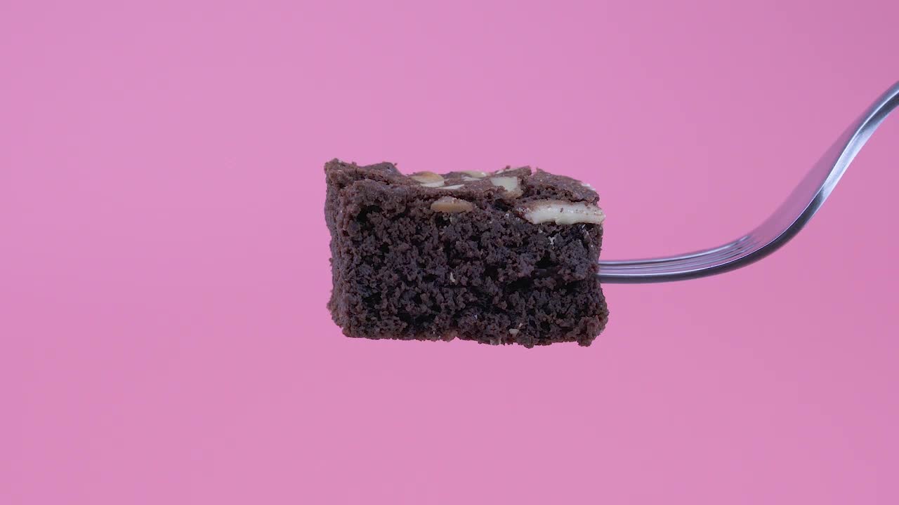 Video Stock Piece Of Brownie On A Fork On A Pink Background Live Wallpaper Free - Free Download