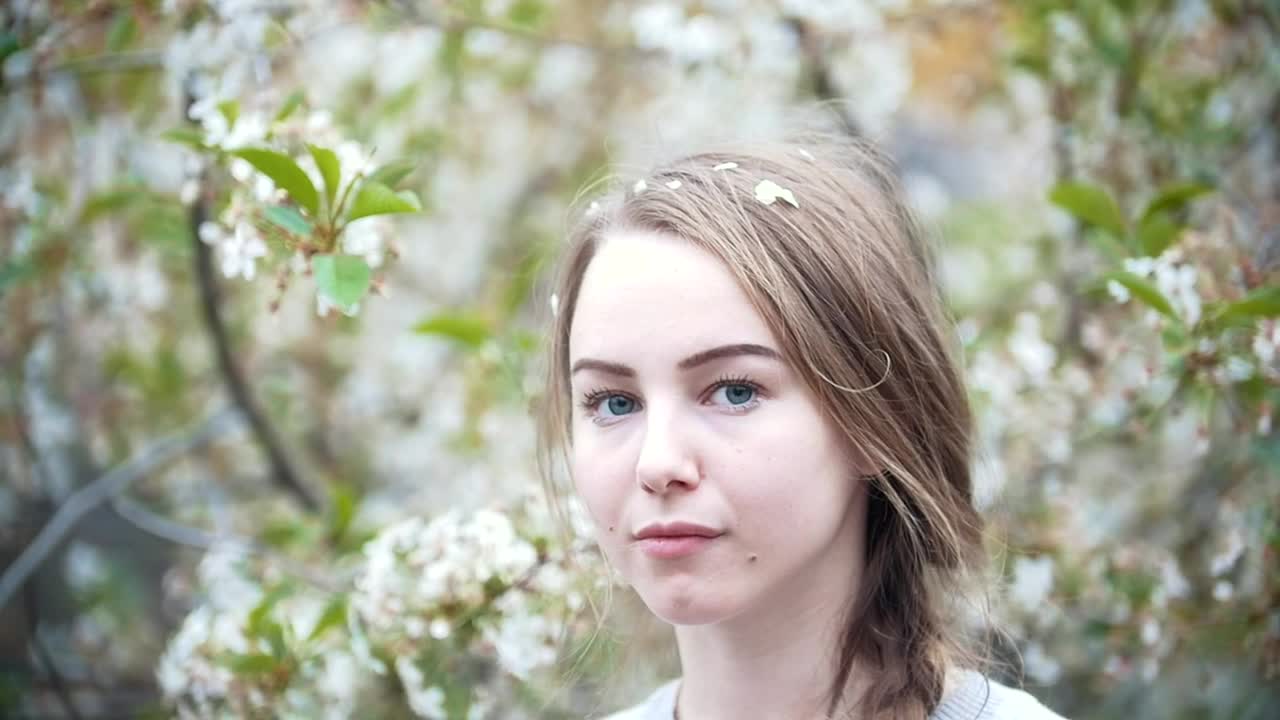 Stock Video Face Of A Young Woman With A Flowering Tree Behind Live Wallpaper For PC - Free Download