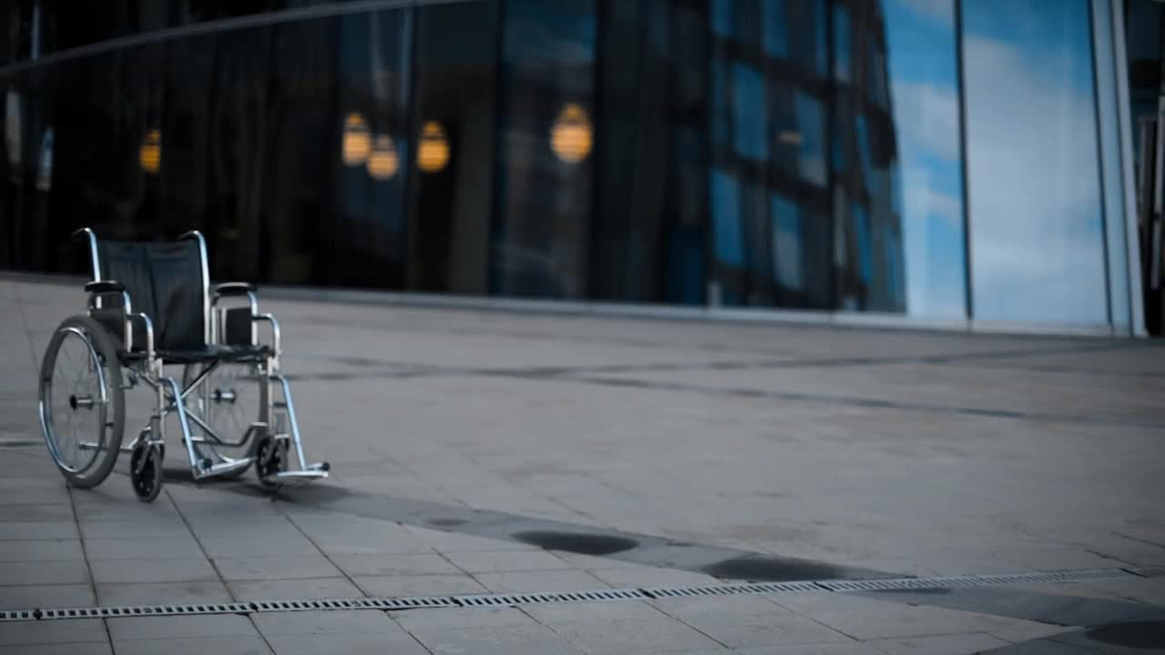 Stock Footage Wheelchair Walking Alone On The Sidewalk Live Wallpaper - Free Download