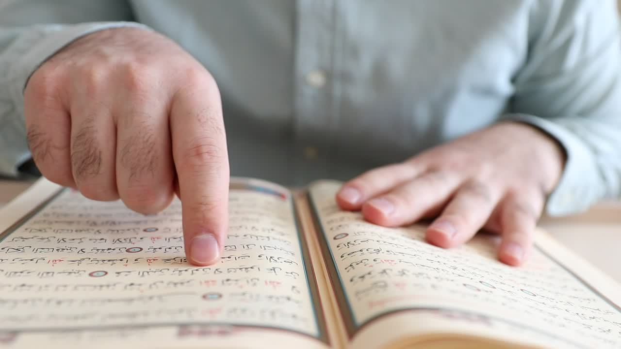 Stock Video Man Running His Finger On The Pages Of The Qura Animated Wallpaper - Free Download