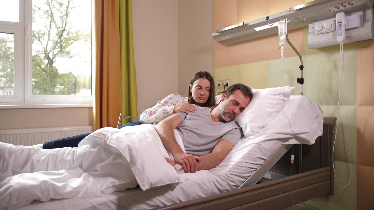 Stock Footage Wife Comforting Her Ill Husband Live Wallpaper - Free Download
