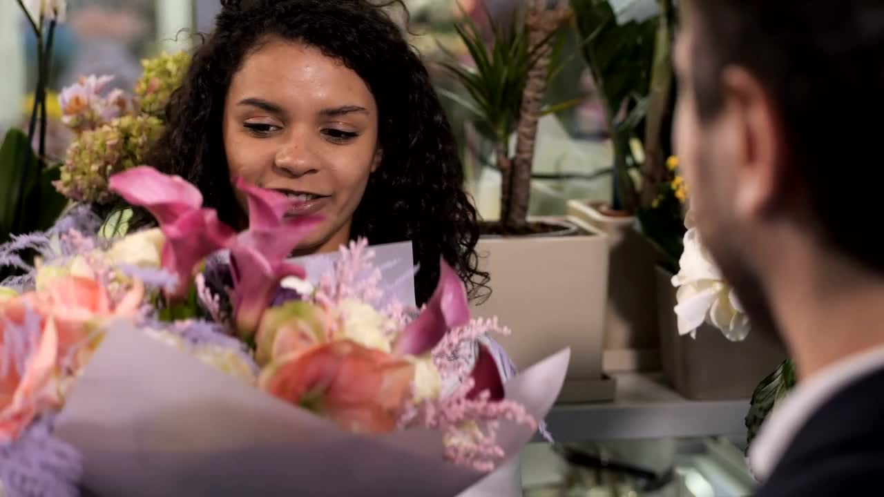 Stock Video Florist Handing A Bundle Of Flowers To A Customer Live Wallpaper For PC - Free Download