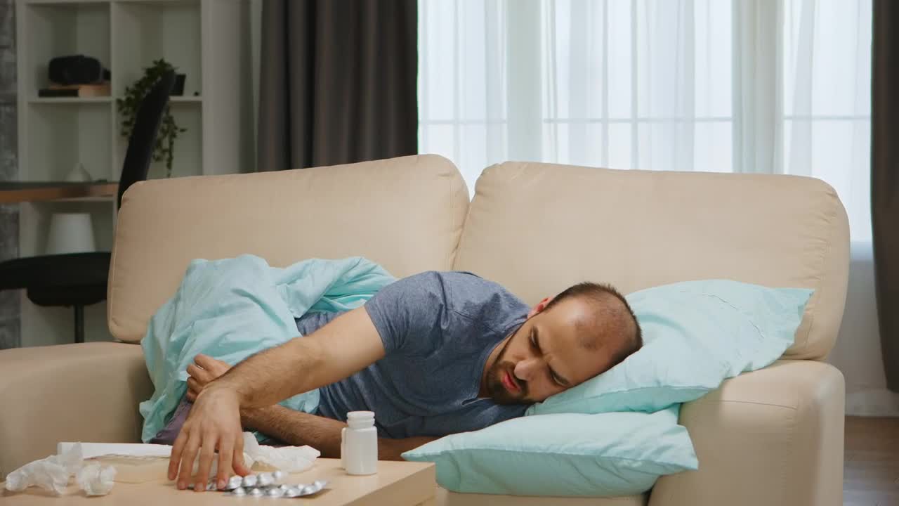 Free Stock Video Sick Man Lays On Sofa And Looks At Medication Live Wallpaper - Free Download
