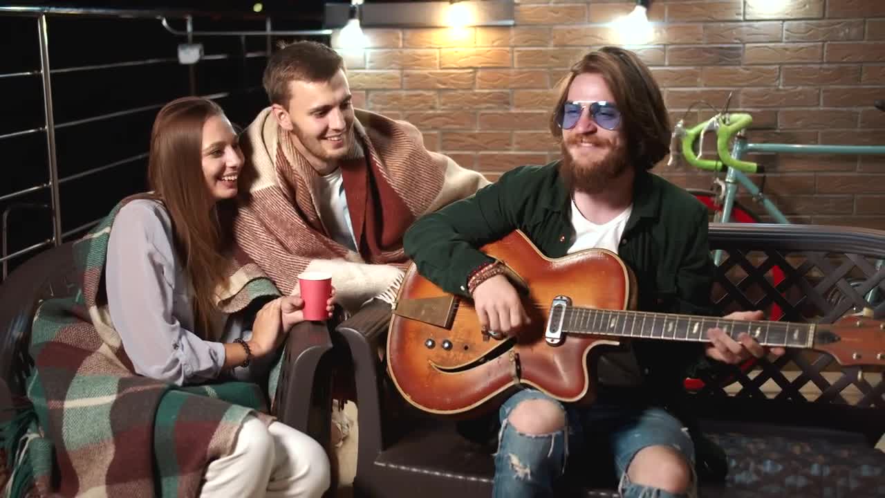 Stock Video Man Plays Guitar For Friends On Relaxing Evenin Animated Wallpaper - Free Download