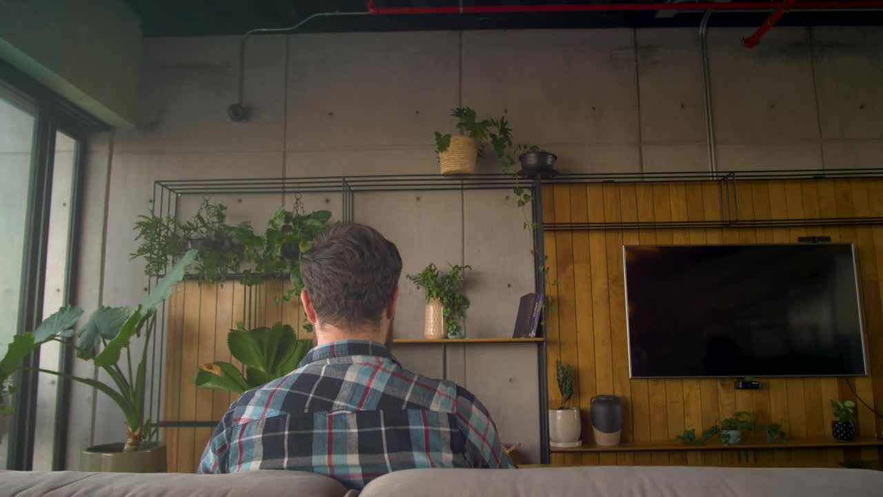 Stock Video Man Sitting On A Couch Uses Virtual Reality Glasse Animated Wallpaper - Free Download