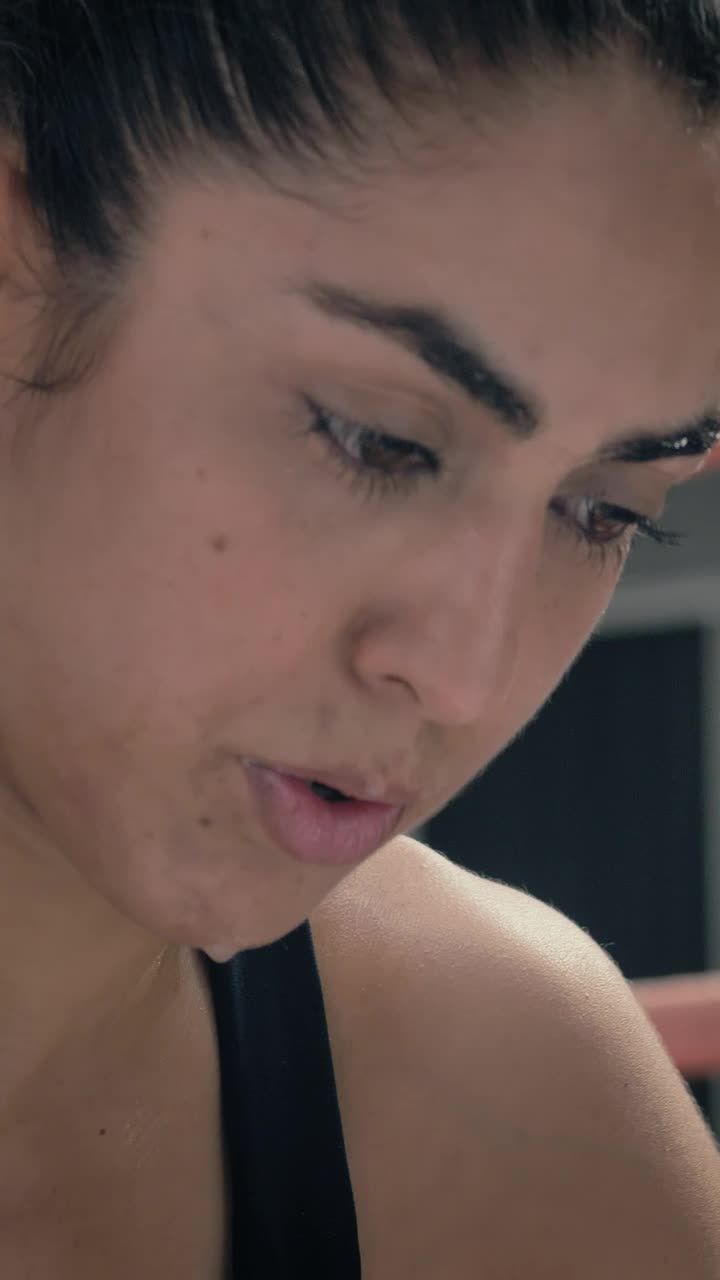 Free Video Stock tired female kickboxer resting after workout Live Wallpaper - Free Download